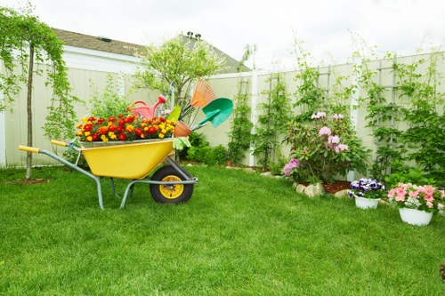 Gardener assisting a customer with accessible tools in a suburban Ickenham garden