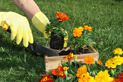 Segregated green waste and recycling containers at a garden site